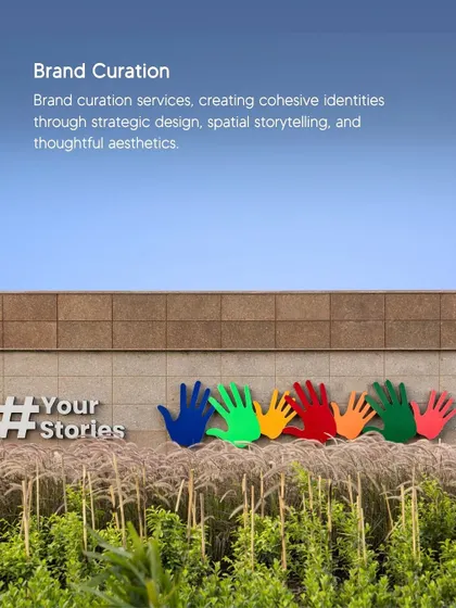 Our brand curation services create cohesive identities through strategic design and spatial storytelling. This outdoor installation, with its colorful handprints, communicates a message of community and shared stories.