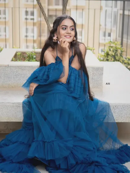 A candid and happy moment in the blue tulle gown. Despite its dramatic look, it's designed to be comfortable and easy to move in.