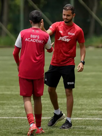 A high-five between a coach and a player shows the mutual respect and shared joy of victory.