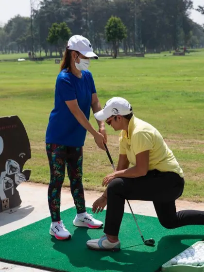 A key part of my adaptive golf coaching is demonstrating posture and movement through physical guidance. This helps students with vision impairment build muscle memory for their swing.