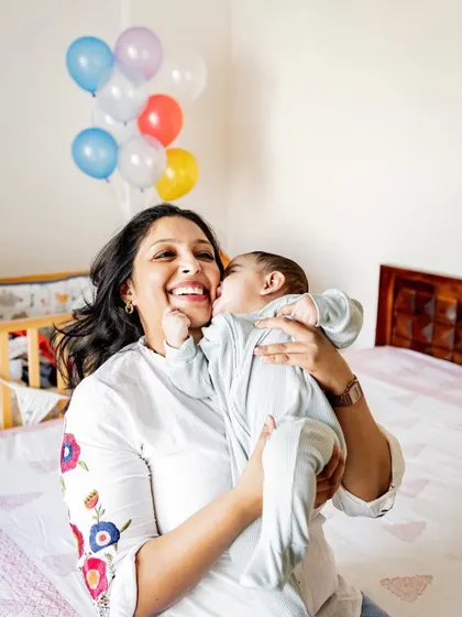 "I'm gonna bite your cheeks, mumma!" This playful moment is even more charming in black and white, focusing on the pure joy and laughter.