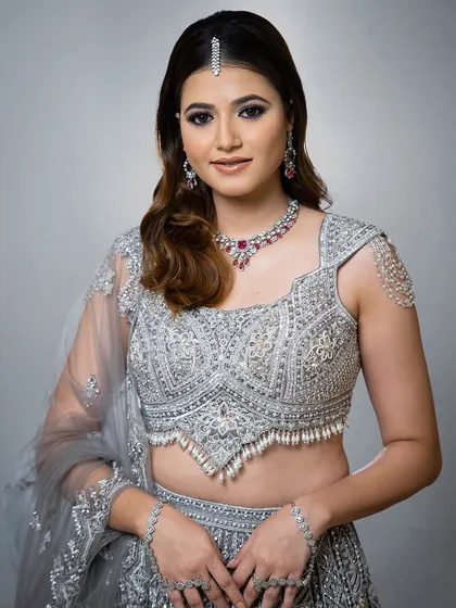 A full view of the silver-grey lehenga with a ruby and diamond necklace. A perfect rental for a glamorous cocktail or reception night.