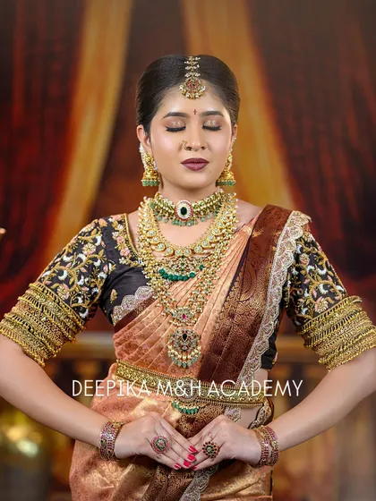 A serene portrait of the bride with her eyes closed, emphasizing the flawless eye makeup and the traditional jewelry. This pose captures a moment of quiet beauty.