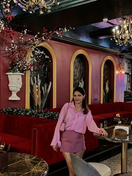 Another view of the pink outfit in a beautifully decorated restaurant. This look is perfect for a dinner date or an evening with friends.