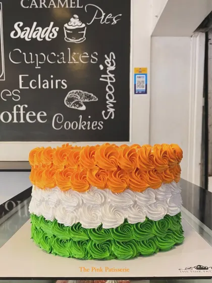 A patriotic cake for Independence Day, decorated with saffron, white, and green buttercream rosettes to represent the Indian flag.