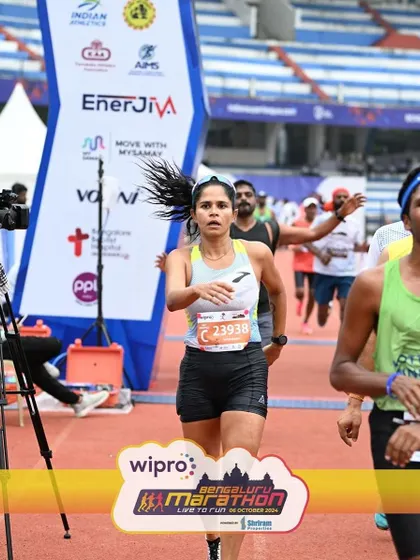 Approaching the finish line at the stadium. The energy of the crowd and the sight of the finish can give you that final push. We practice finishing strong in training so you're ready for this moment.