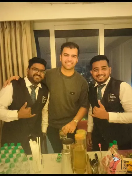 Our bartenders with a happy client at a house party. We bring the full professional bar experience to even the most intimate gatherings.