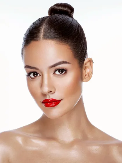 A classic beauty portrait with a bold red lip and clean, glowing skin. This timeless look is a must-have in any professional portfolio.