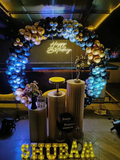 My services are perfect for adult milestone birthdays in any setting, including pubs and lounges. This moody and elegant setup uses a black and gold balloon arch over pedestals, with a custom neon 'Happy Birthday' sign and dramatic lighting to create a sophisticated party atmosphere.