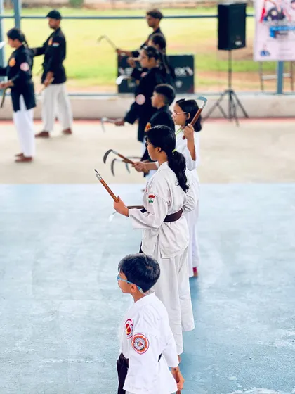 Young martial artists lined up, ready for their next instruction during the weapons training seminar.