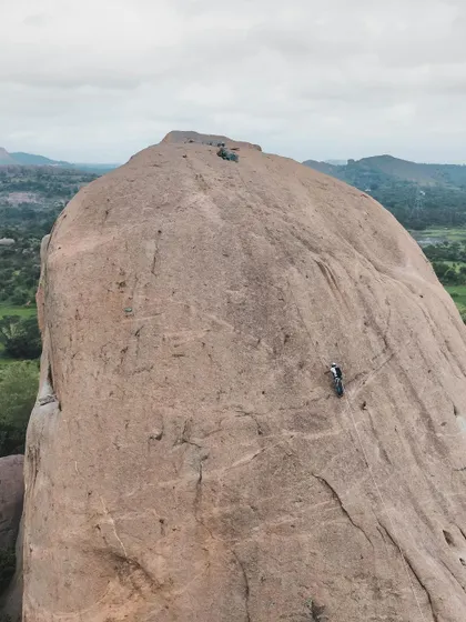 A lone climber on the vast face of Gaali Kallu. This image captures the scale and solitude that can be found on these big rock formations.
