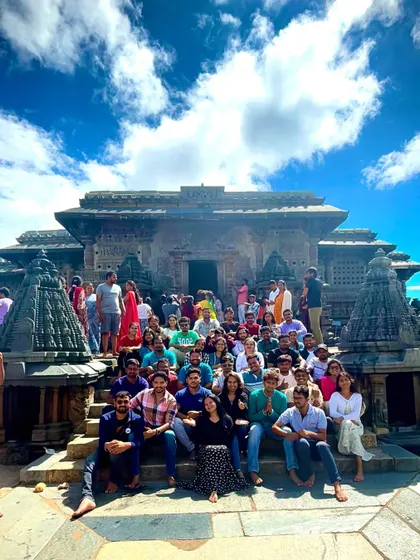 A large group photo capturing the grandeur of the Hoysaleswara temple in Halebidu. These trips are perfect for history buffs and architecture lovers.