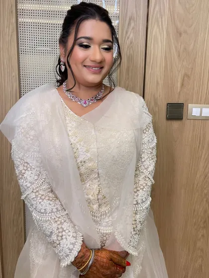 This bride's sangeet look in a white outfit is pure celestial glam. I created a stylish ponytail with star-shaped accessories to match the theme.