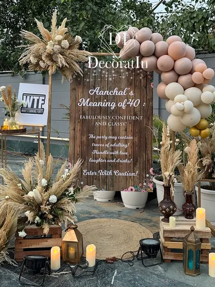 Another daytime shot of the welcome area, showcasing the full arrangement of props, including lanterns, crates, and potted plants.