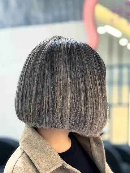The back view of this ash bob, showing the clean lines of the cut and the beautiful, cool-toned dimension of the color.
