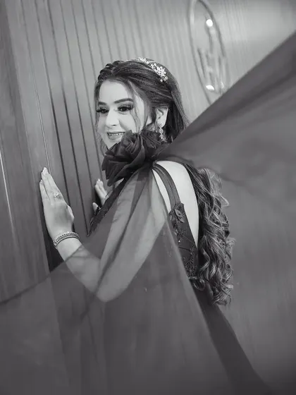 The same stunning bridal portrait in timeless black and white. This version emphasizes the texture of the gown and the bride's elegant pose.