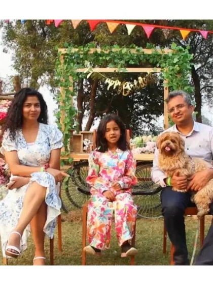 A family posing in front of one of our beautiful, rustic photo backdrops.