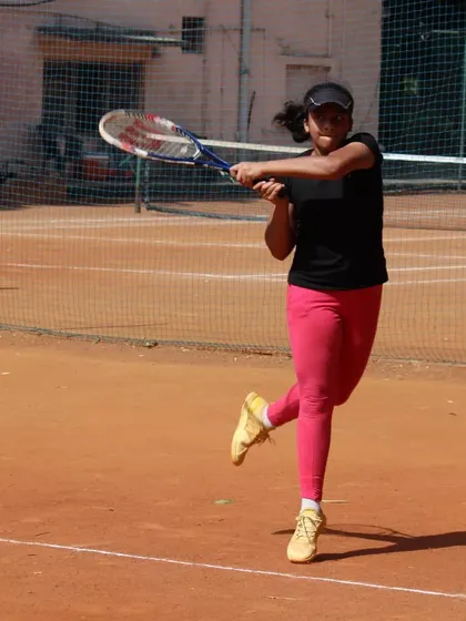 An action shot of a player executing a clean backhand during a tournament match. We work on developing solid groundstrokes on both wings.