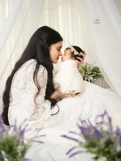 A mother's world, held gently in her arms. I love capturing this tender bond in a soft, dreamy setting.