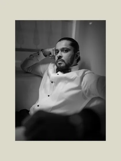 A handsome black and white portrait of the groom. His confident expression and classic tuxedo make for a timeless and striking image.