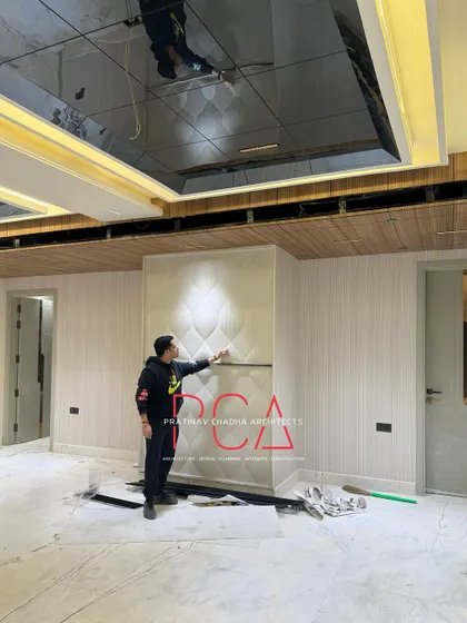 An on-site image from the Outram Lines luxury residence, showing the installation of custom wall panels in the living room.