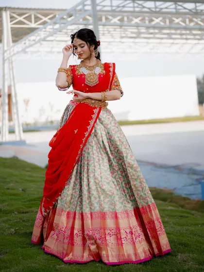 A graceful pose showcasing the elegance of the bride's movements. The flow of the dupatta and the intricate hand gestures are beautifully captured.
