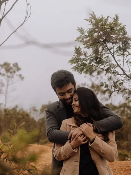A cozy and loving hug amidst a misty, wooded landscape. This image evokes a sense of warmth, protection, and quiet intimacy.