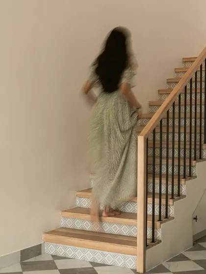 A motion-blur shot capturing the life and movement within the home. The staircase is not just a functional element but a beautiful design feature that connects the different zones of the house.