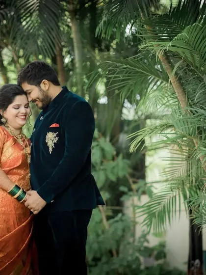 A sweet portrait of the newly married couple holding hands in a quiet garden, enjoying their first moments as husband and wife.