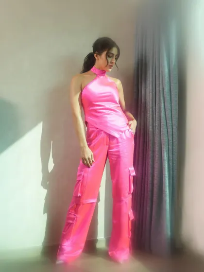 A full-length view of the vibrant pink outfit, maintaining the soft and dreamy lighting effect throughout the frame.