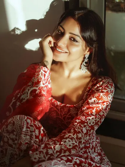 A warm, sun-kissed portrait of actress Symrann K in a beautiful red ethnic outfit. This photo highlights my skill in ethnic glamour photography, using natural light to create a soft and inviting mood.