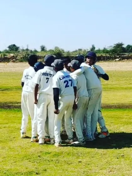 A team huddle during the Chitradurga tour, strategizing for the win.
