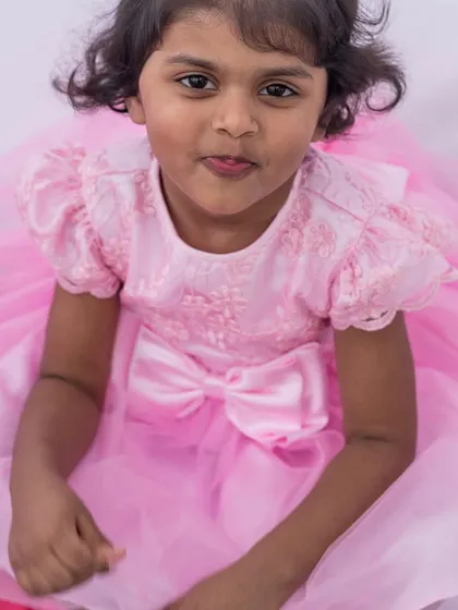 Pretty in pink from head to toe. This party dress features an embroidered bodice, sweet puff sleeves, and a full, flowing skirt that makes any little girl feel like a princess.