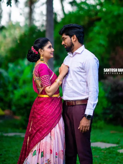 A beautiful portrait of a couple in traditional attire, sharing a quiet moment in a garden.