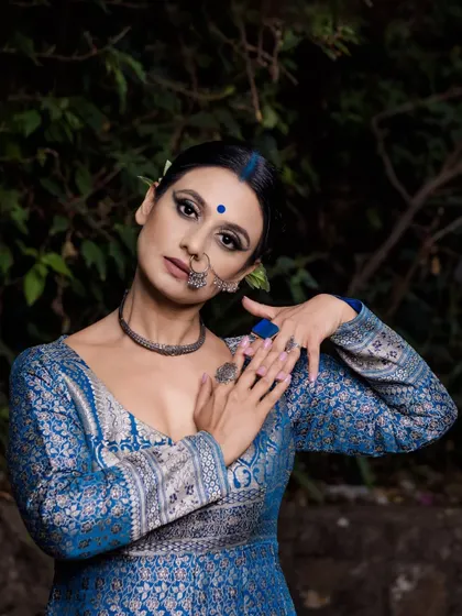 A final portrait from the "Neeli Nazakat" series, capturing a look of poise and intensity. The lighting is crafted to highlight the model's striking features and the elegant details of her traditional Indian attire.