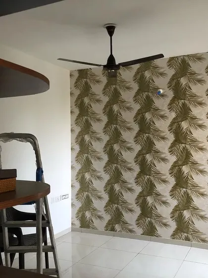 A final look at the palm leaf wallpaper project, showing the clean installation around a doorway.