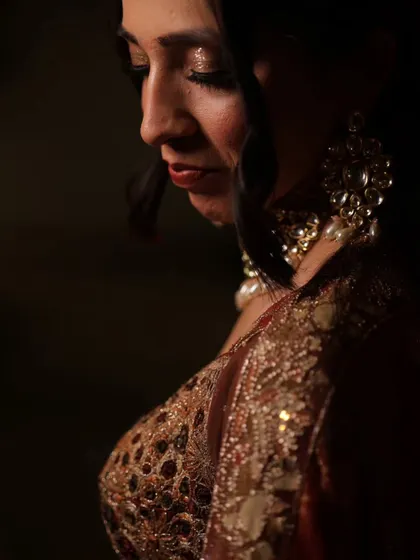A moody, artistic shot highlighting the side profile and the soft glam makeup. Perfect for creating memorable engagement photos.