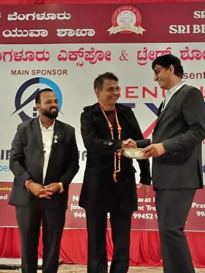 Being felicitated on stage at a business expo. I am proud to be recognized for my work and enjoy hosting professional and formal events.