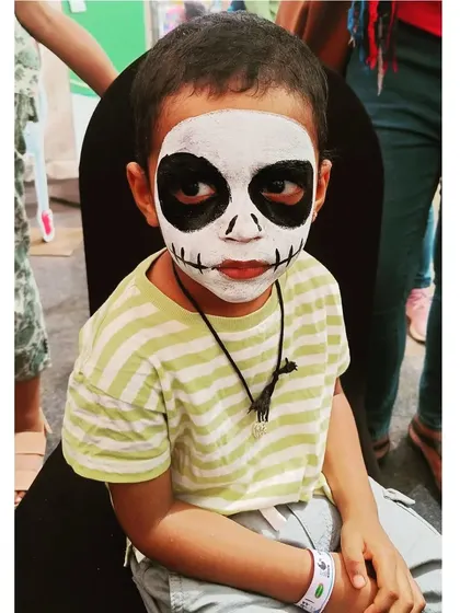 A spooky and fun full-face skeleton, perfect for Halloween parties or themed events. This look is created with high-contrast, non-toxic black and white paint for a dramatic effect.