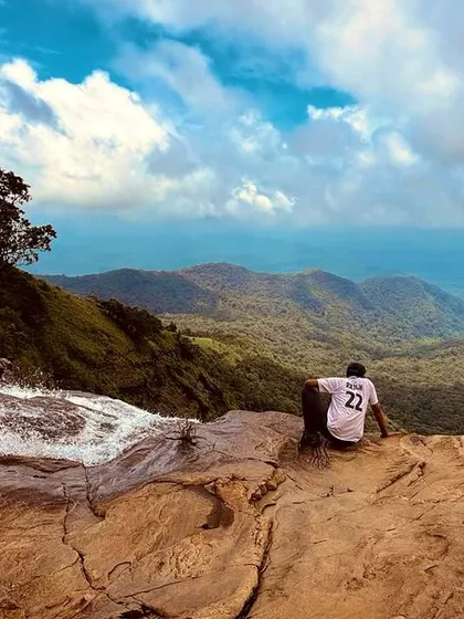 Taking a moment to soak in the vastness from the top of Bandaje Falls. The view of the valley below is just as impressive as the waterfall itself.
