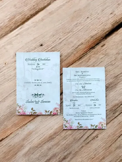 This classic invitation features a pink floral border and a traditional horse-drawn carriage motif, starting at just ₹9.
