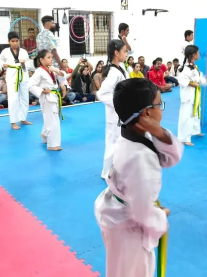 A class of yellow and green belts, focused and ready.