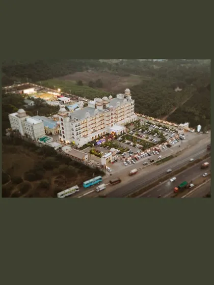 A sweeping aerial view of the magnificent wedding venue. This shot establishes the grand scale and beautiful location of the celebration.