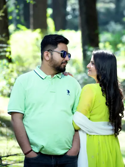 A sweet, candid moment where the couple shares a look in the middle of a sun-dappled forest. Capturing these in-between moments is key to my photography style.