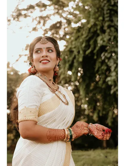 A beautiful portrait of the bride holding a flower, her smile genuine and warm.