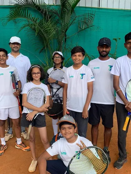 Another great group of our students and coaches posing after a productive training session on the clay court.