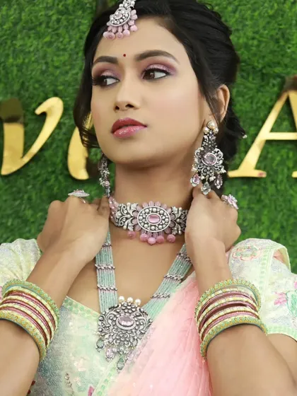 This bride is wearing a modern Victorian-style set with pink stones. The silver-toned antique finish is very unique.