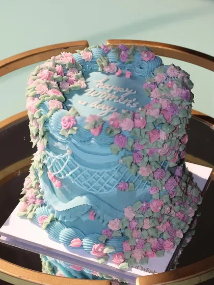 The sunlight catching the details of our Women's Day cake. The combination of blue, pink, and green makes it a fresh and vibrant celebration cake.