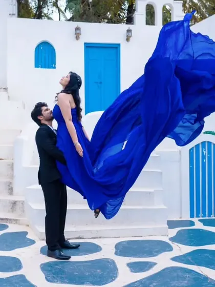 A duplicate of image 64, showing a fun and dynamic lift pose. The flowing blue gown adds a sense of motion and excitement to the pre-wedding photo.