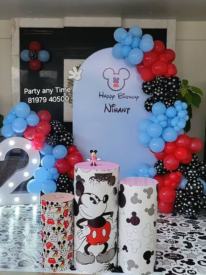 Another Mickey Mouse setup for a 2nd birthday, featuring a custom arch backdrop and a printed floor mat to complete the theme.